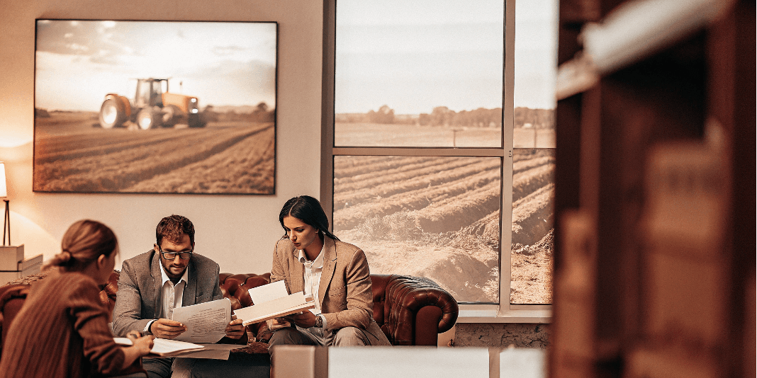 Farmer in field with industrial facilities